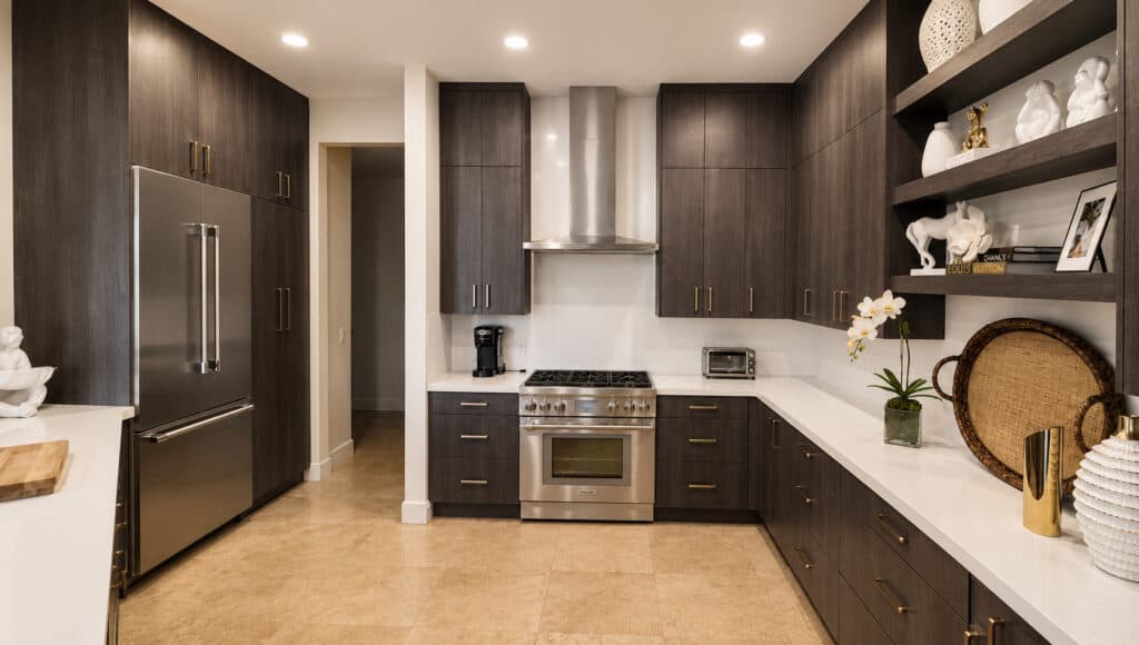 West Palm Beach Ibis kitchen with dark wood cabinets, open floating shelves, a stainless pro range, and white quartz counters.